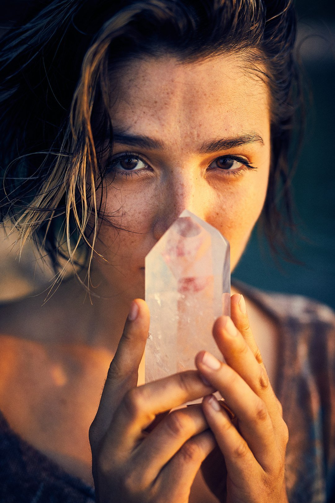 Beautiful brunette holding a spiritual crystal.